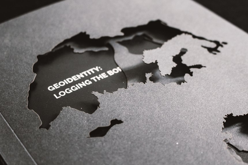 world map cutout in black with project title geoidentity: logging the boarders. Goodvertsing article by Nobantu Modise